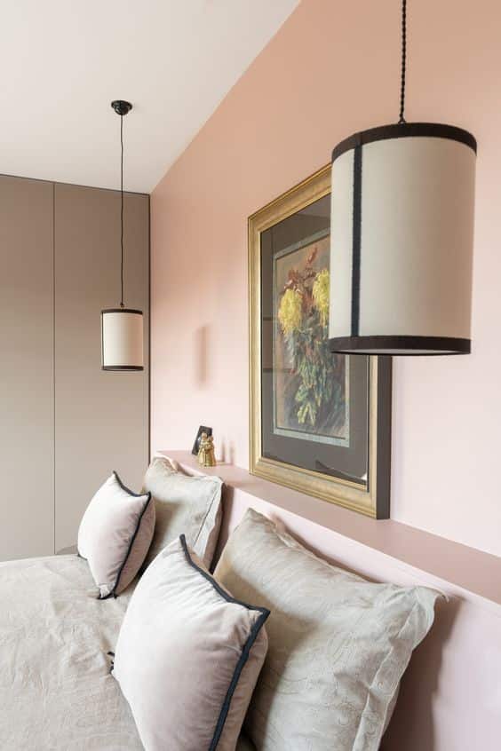 Une chambre moderne avec un mur rose poudré et une parure de lit en lin