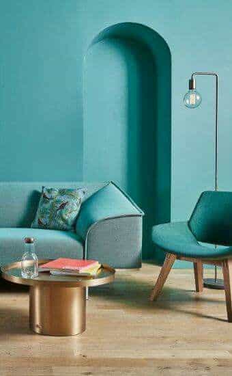 Salon à la décoration turquoise avec mur et canape bleu